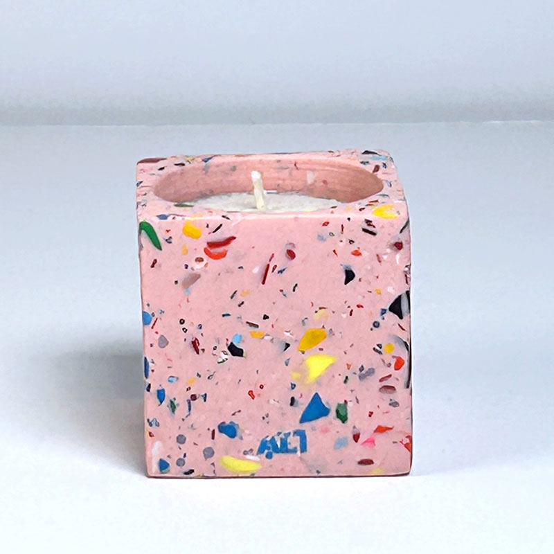 Pink with colourful rainbow confetti terrazzo rectangular tea light candle holder on a light grey background
