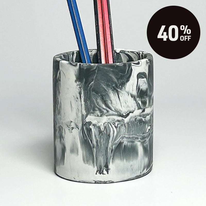 A cylindrical pencil holder with a marble pattern in shades of black, grey and white, shown on a plain light background with a black '40% OFF' promotional sticker in the top right corner.