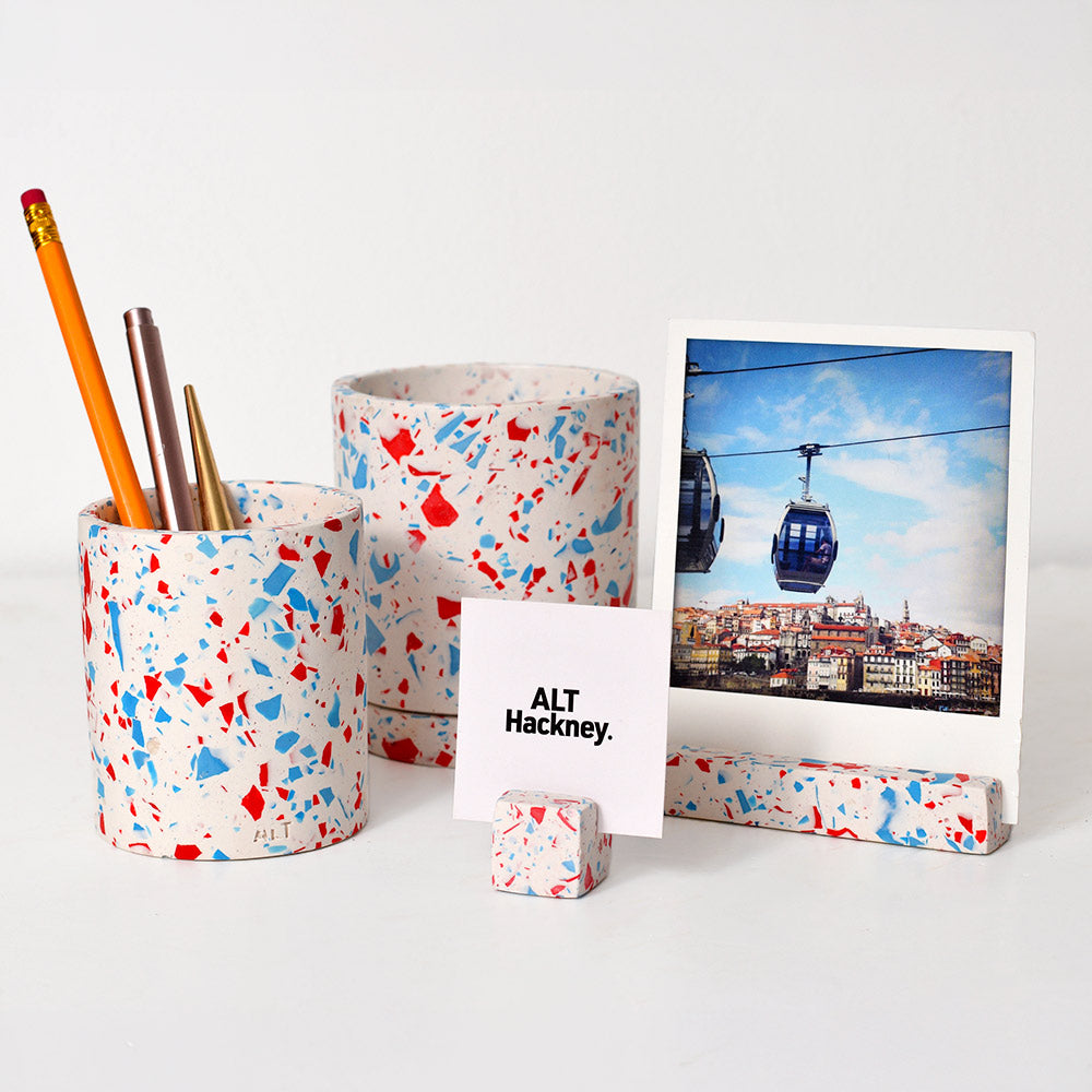 Selection of blue and red terrazzo homeware such as photo holders, a pen pot and a plant pot