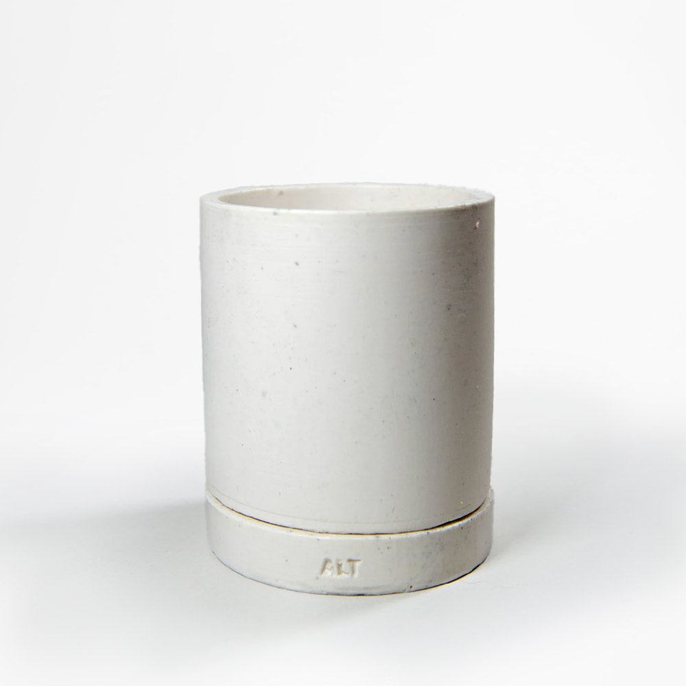 White Jesmonite planter on a light gray background