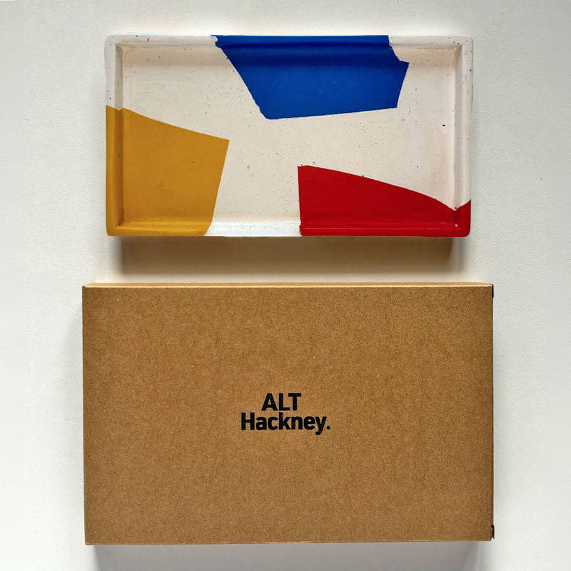 Multi coloured rectangular tray with a brown box with 'ALT Hackney' branding