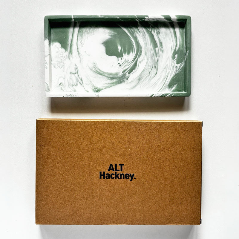 Small Rectangular moss green and white marbled tray with a brown eco box with ALT Hackney logo on a light gray background