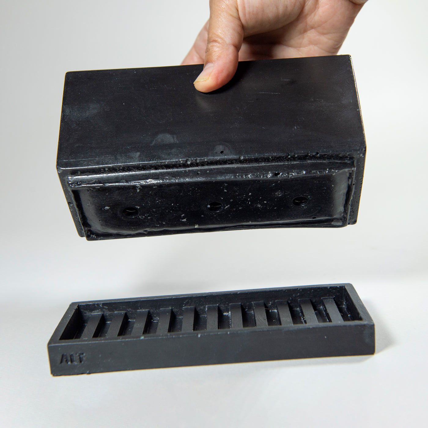 Rectangular black planter with drainage holes and a water tray box with 'ALT' branding on a white background