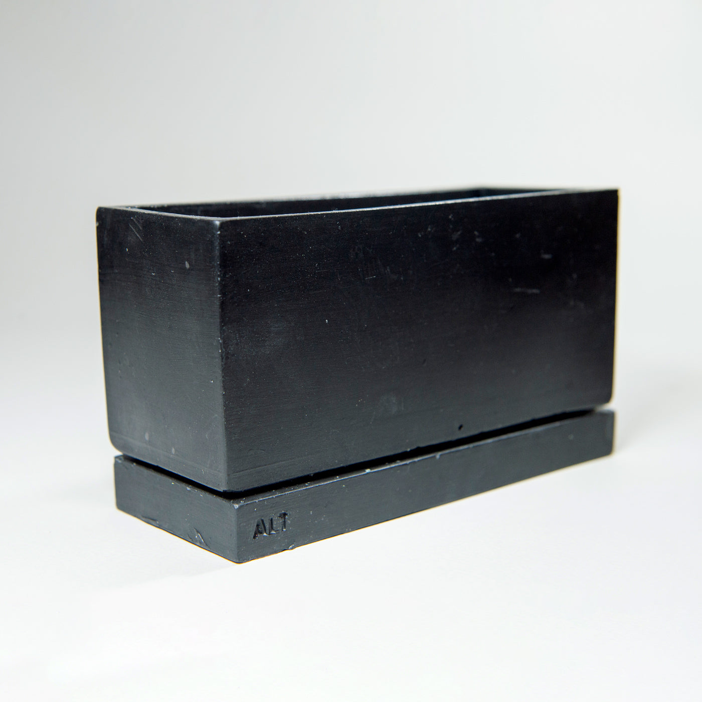 Rectangular black planter with drainage holes and a water tray box with 'ALT' branding on a white background