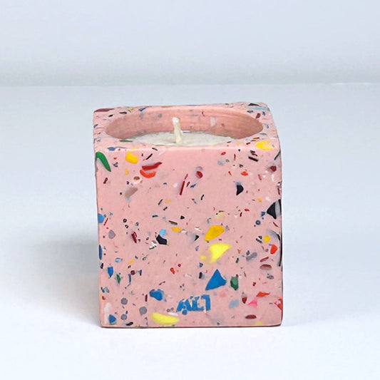Pink with colourful rainbow confetti terrazzo rectangular tea light candle holder on a light grey background
