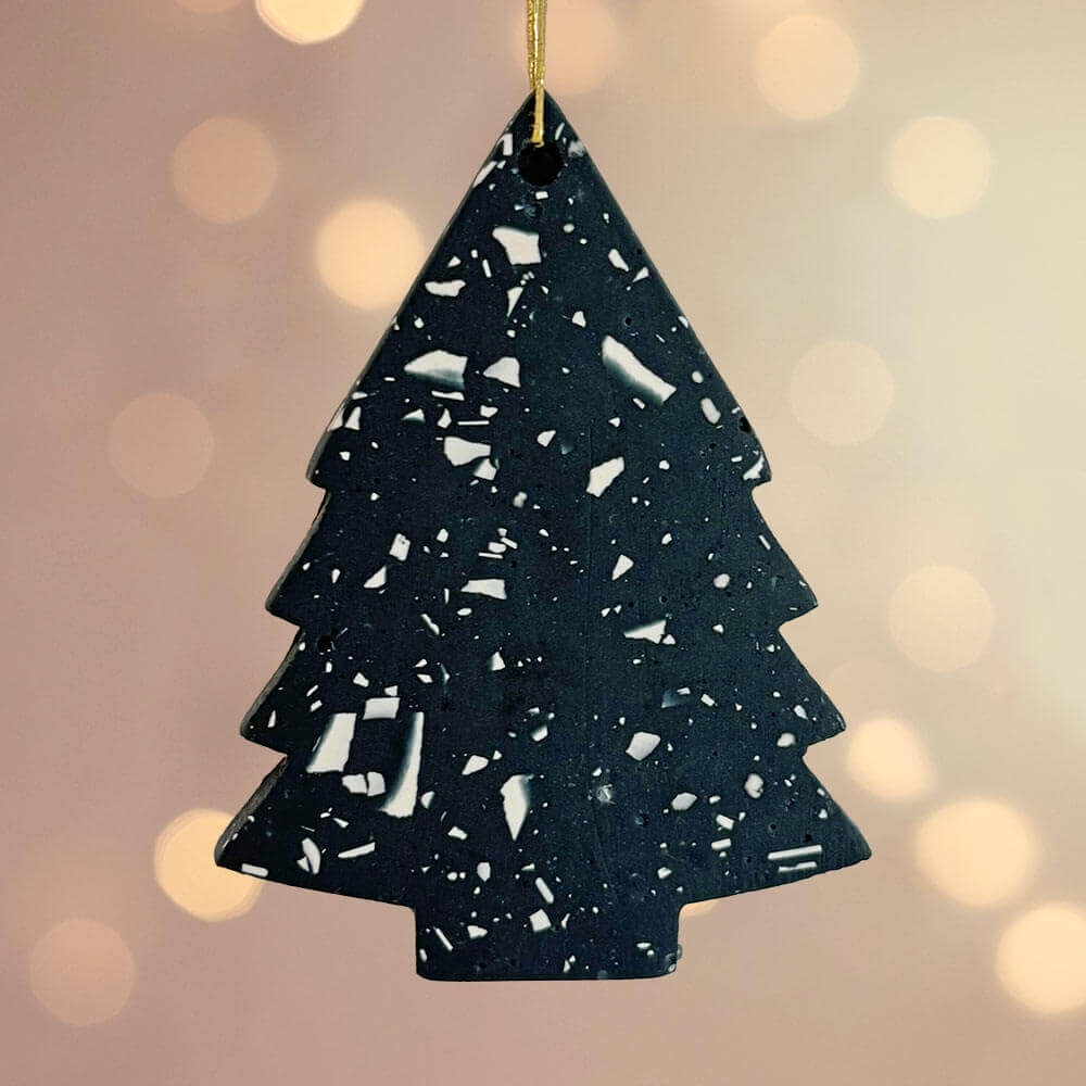 Navy terrazzo Christmas tree ornament on a blurred lights background
