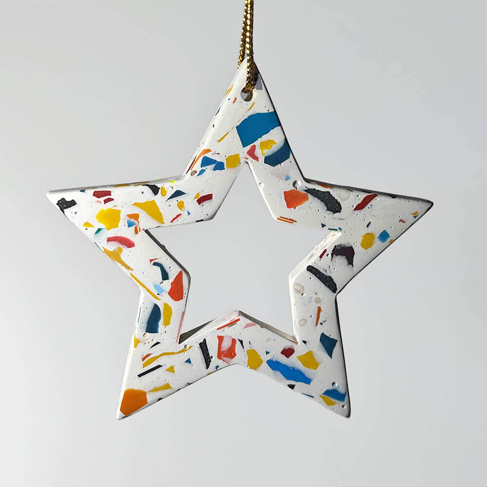 Star-shaped ornament with a colourful rainbow terrazzo on a white background 