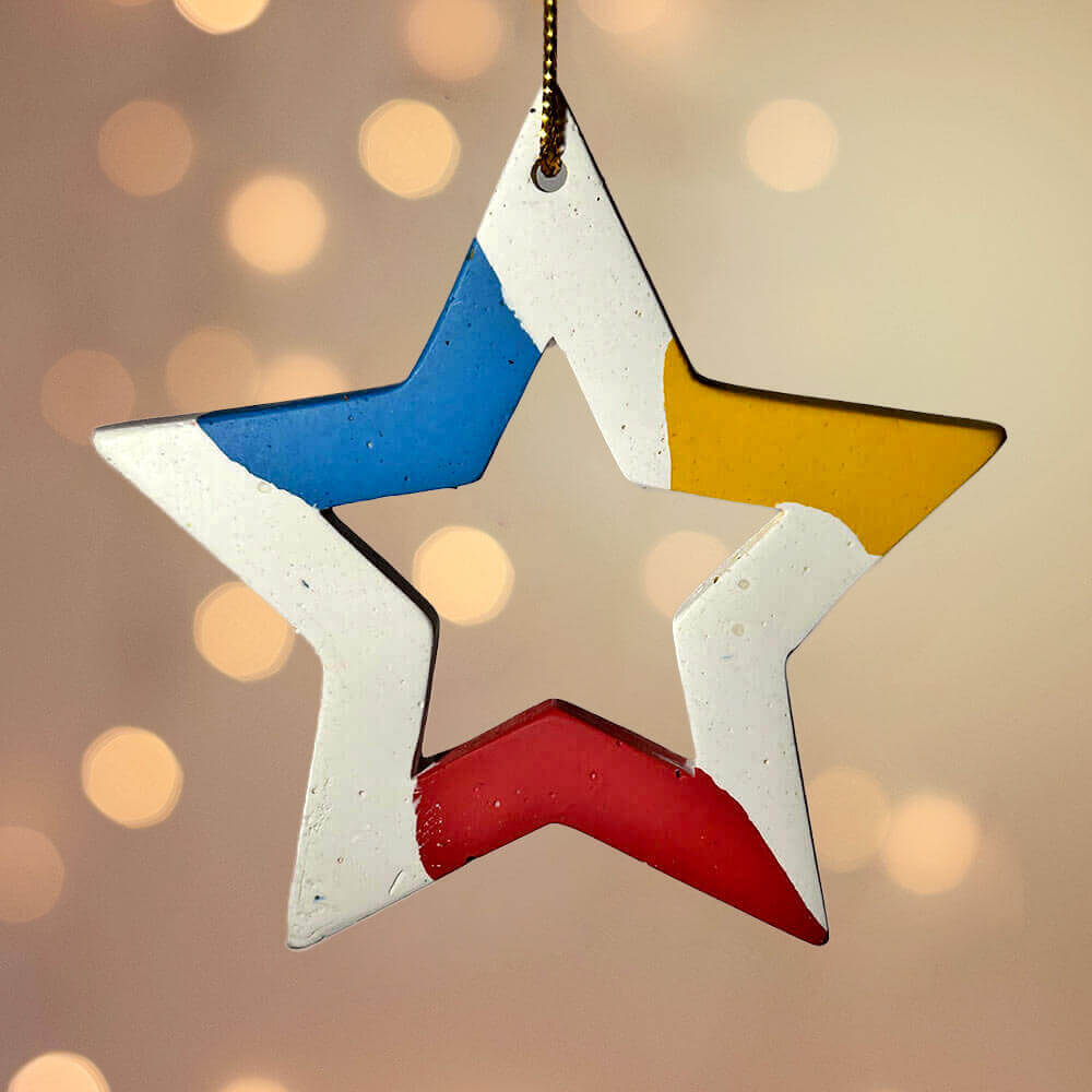 Colorful star-shaped Christmas ornament against a blurred light background