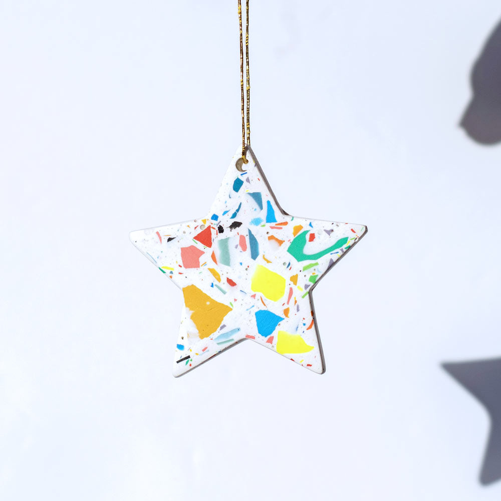 Rainbow terrazzo star-shaped ornament on a white background