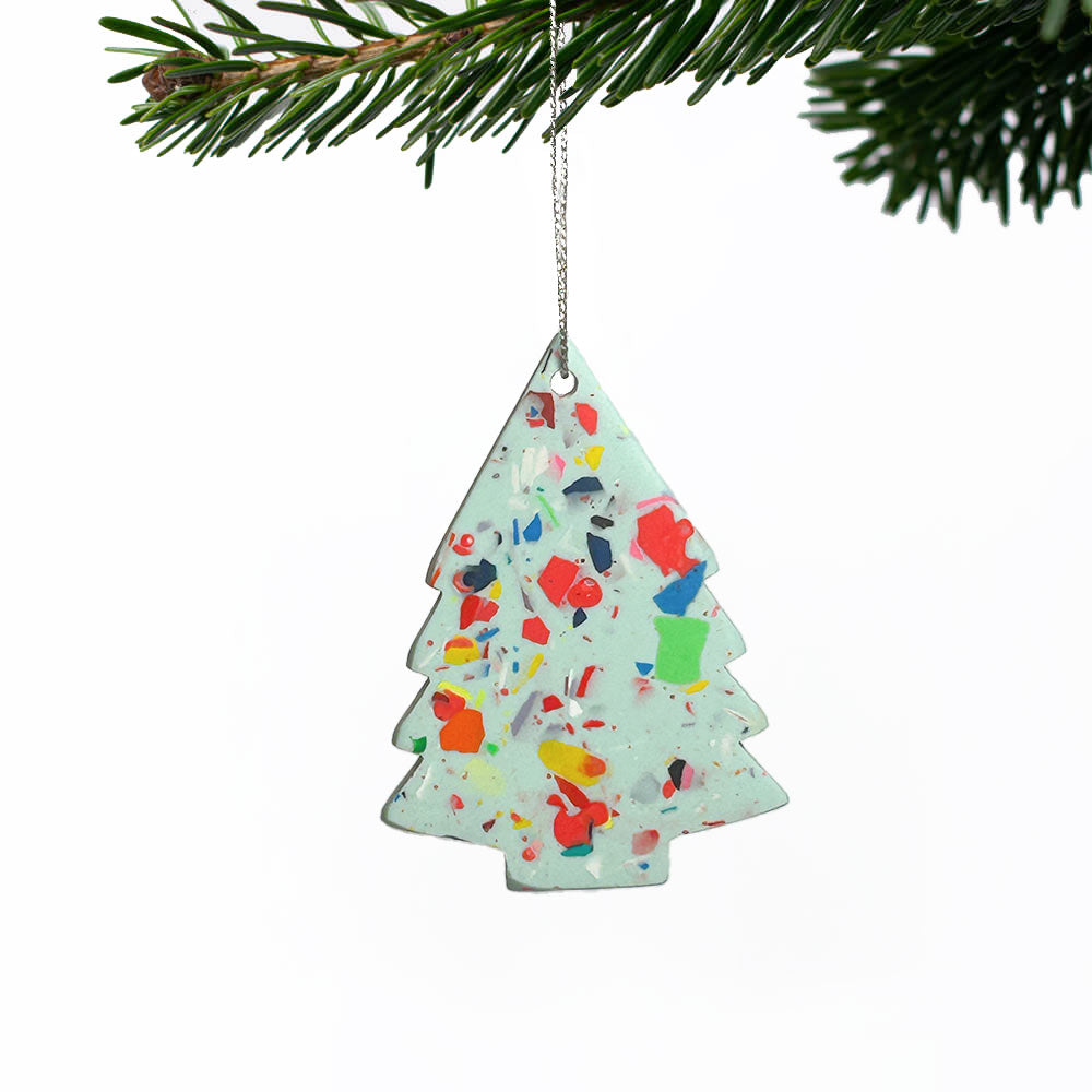 Mint green with rainbow terrazzo tree-shaped Christmas decoration hanging on a Christmas tree branch