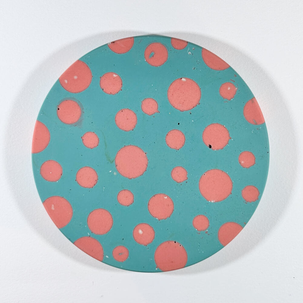 Pink and blue round dot coaster on a white background