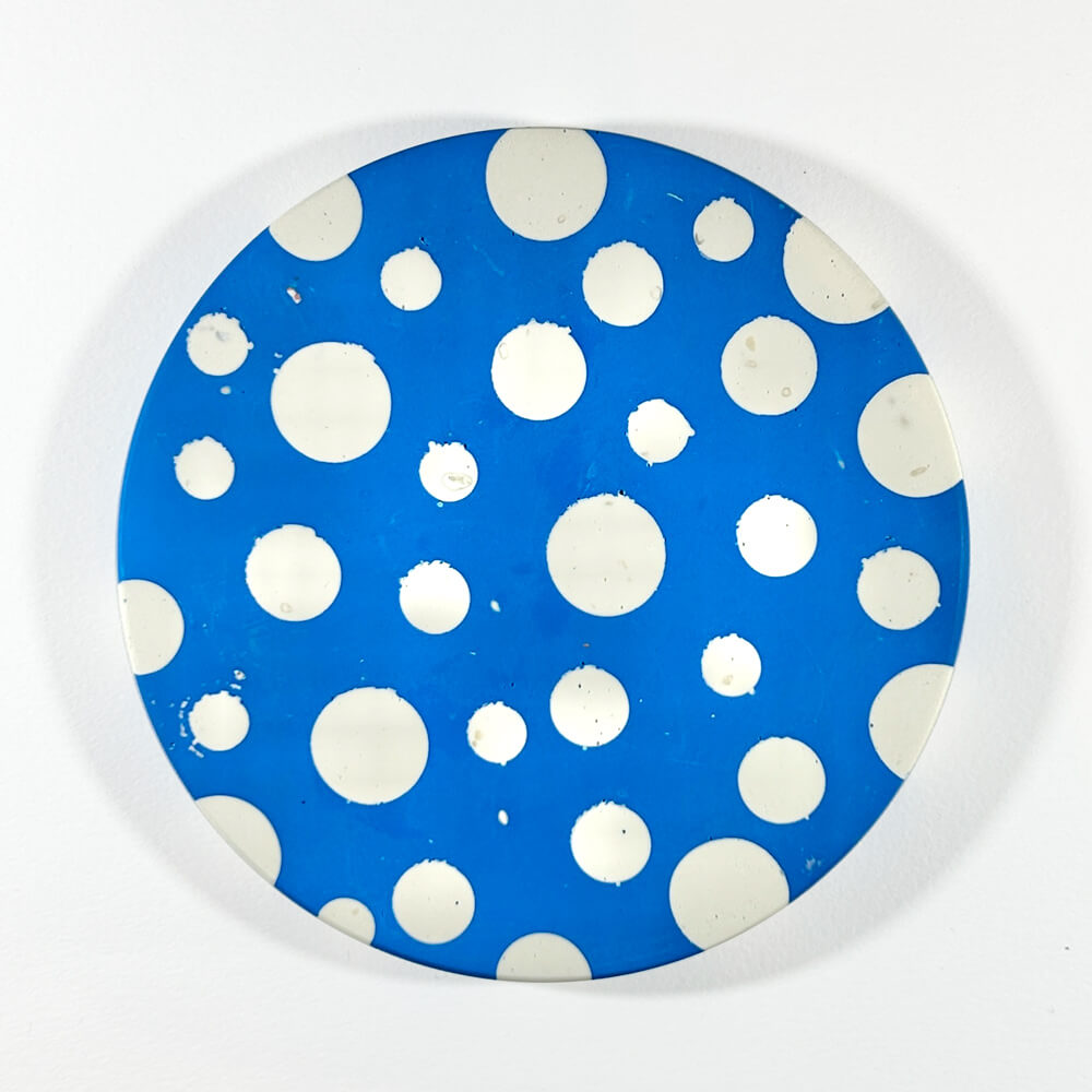 Blue and white round dot coaster on a white background