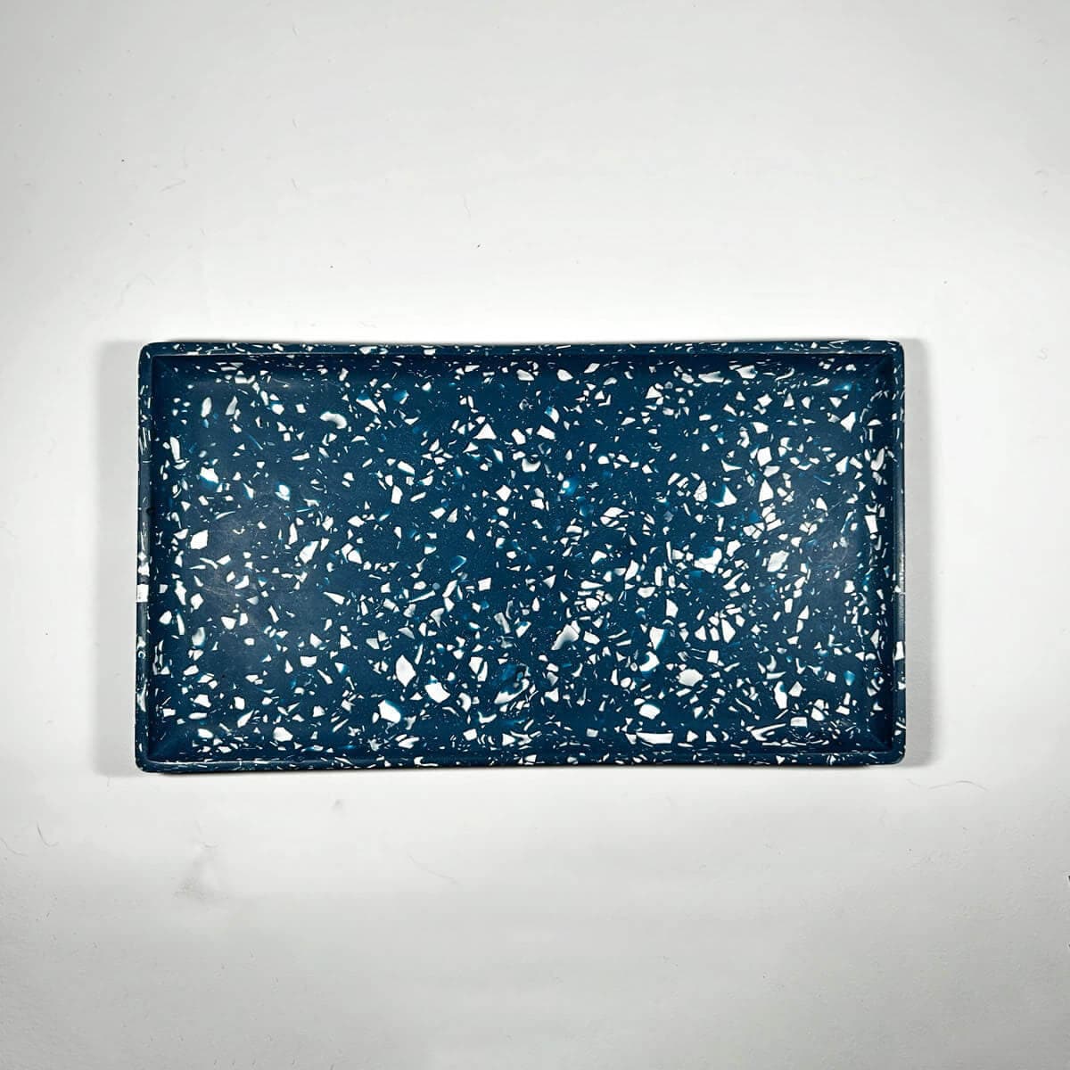 Navy blue speckled rectangular tray on a white background