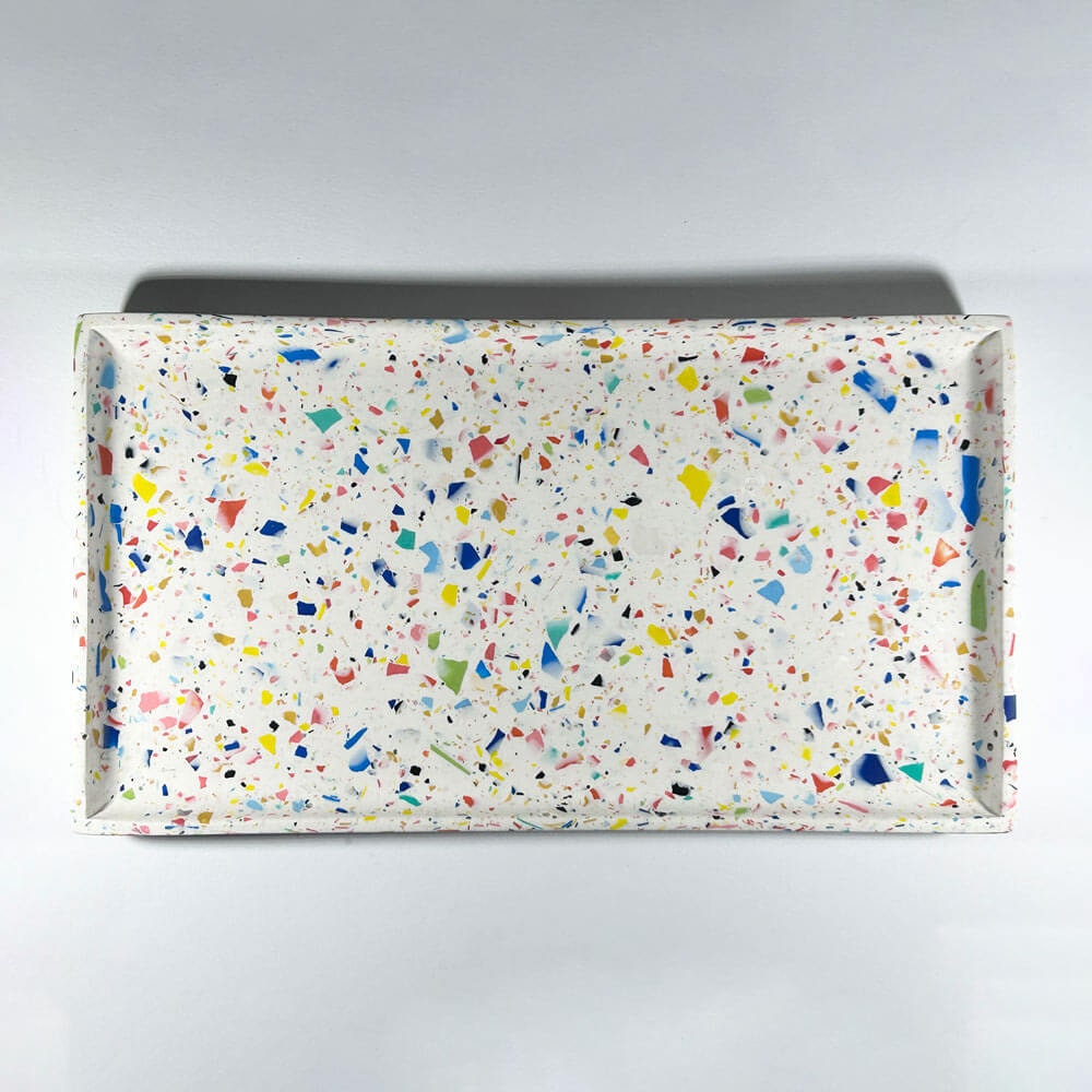 Rectangular tray with multicolored rainbow confetti terrazzo pattern on a white background