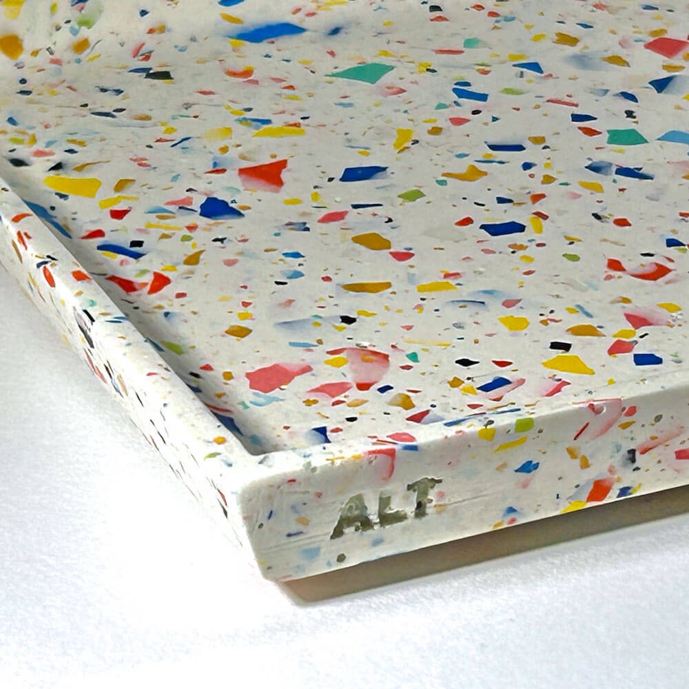 Colorful speckled tray with 'ALT' branding on a white background
