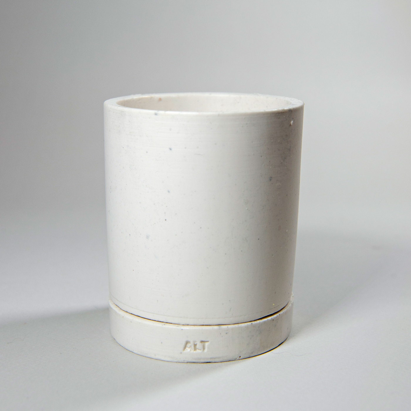 White Jesmonite planter on a light gray background