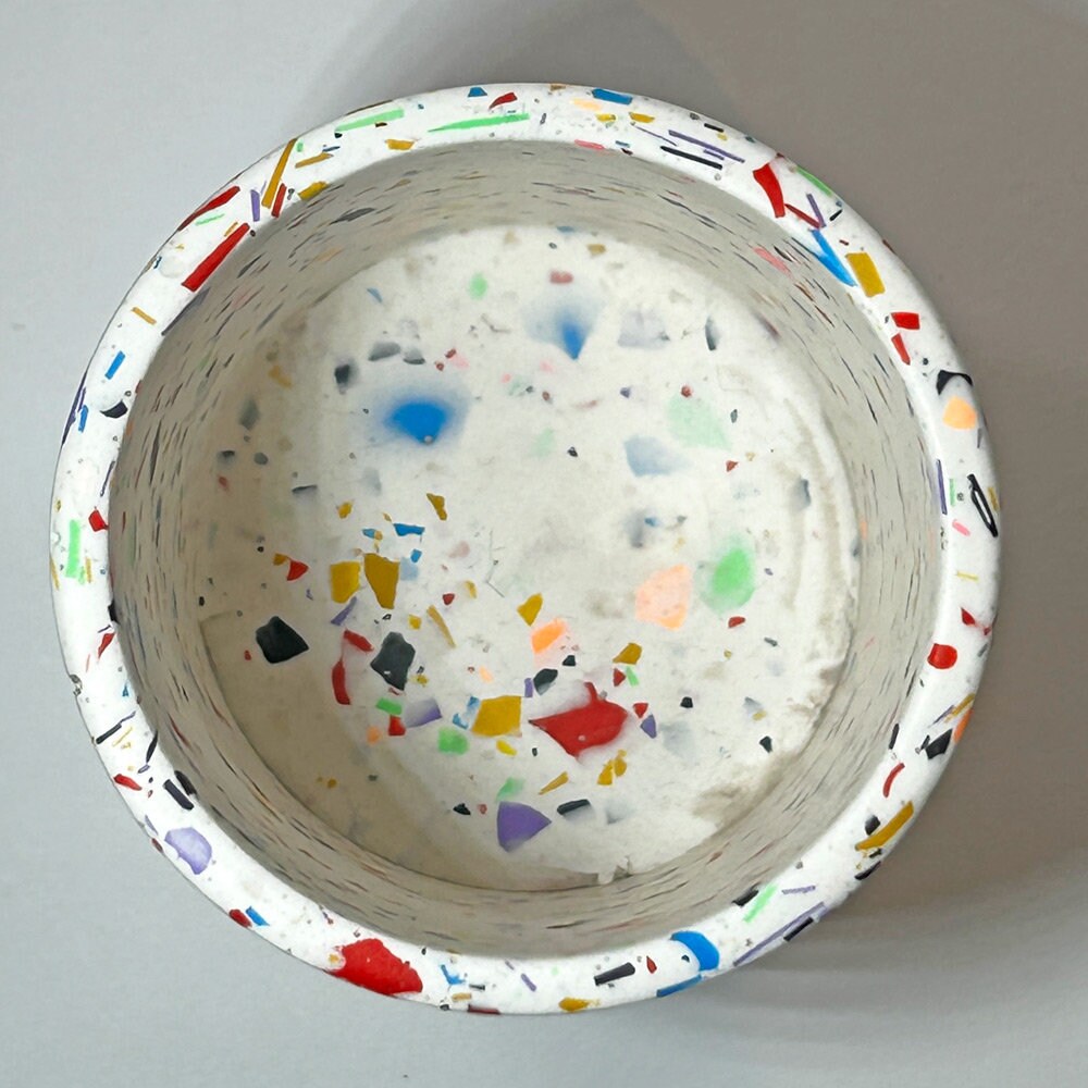 Colorful speckled bowl on a light gray background