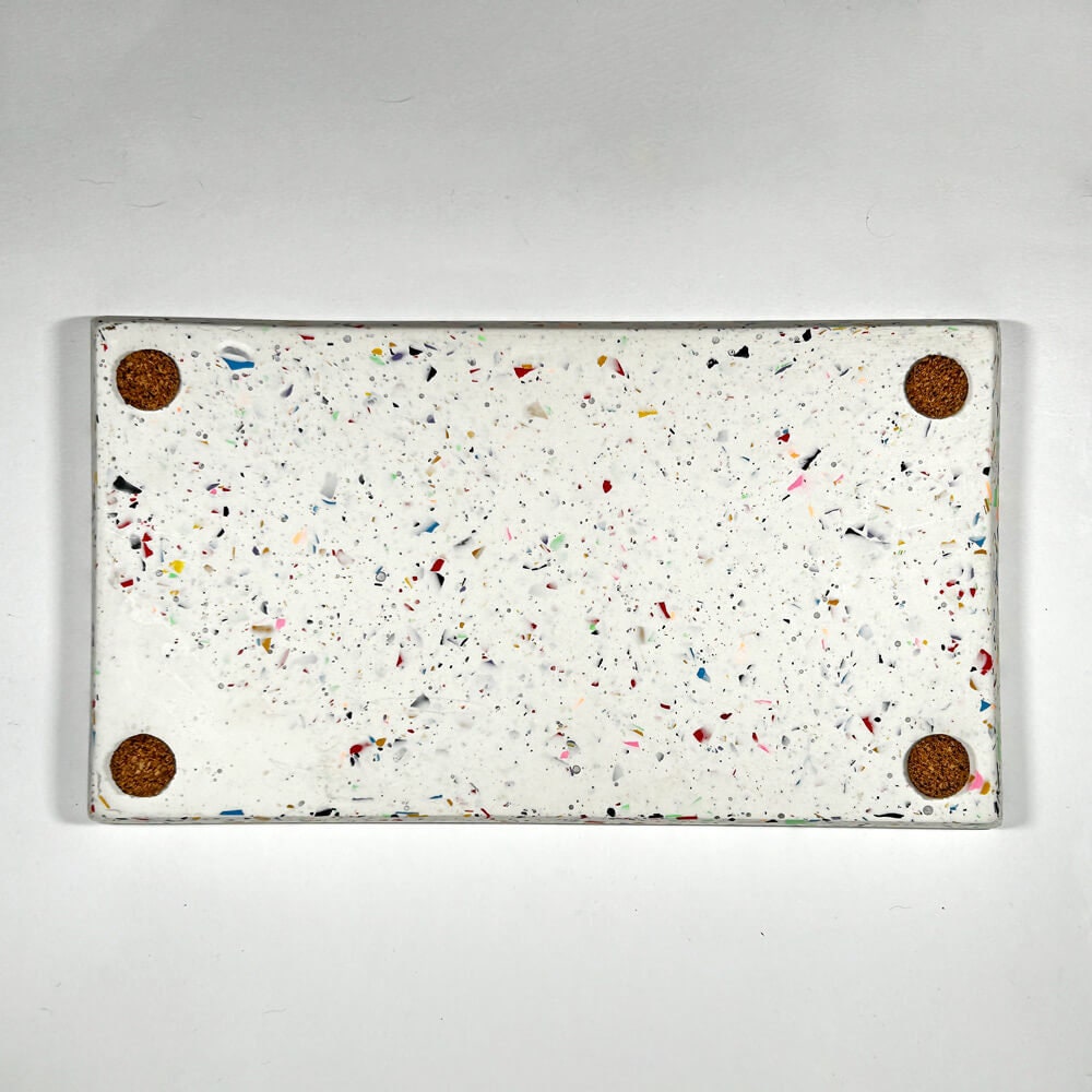 Rectangular white tray with speckles and cork pads on a light gray background