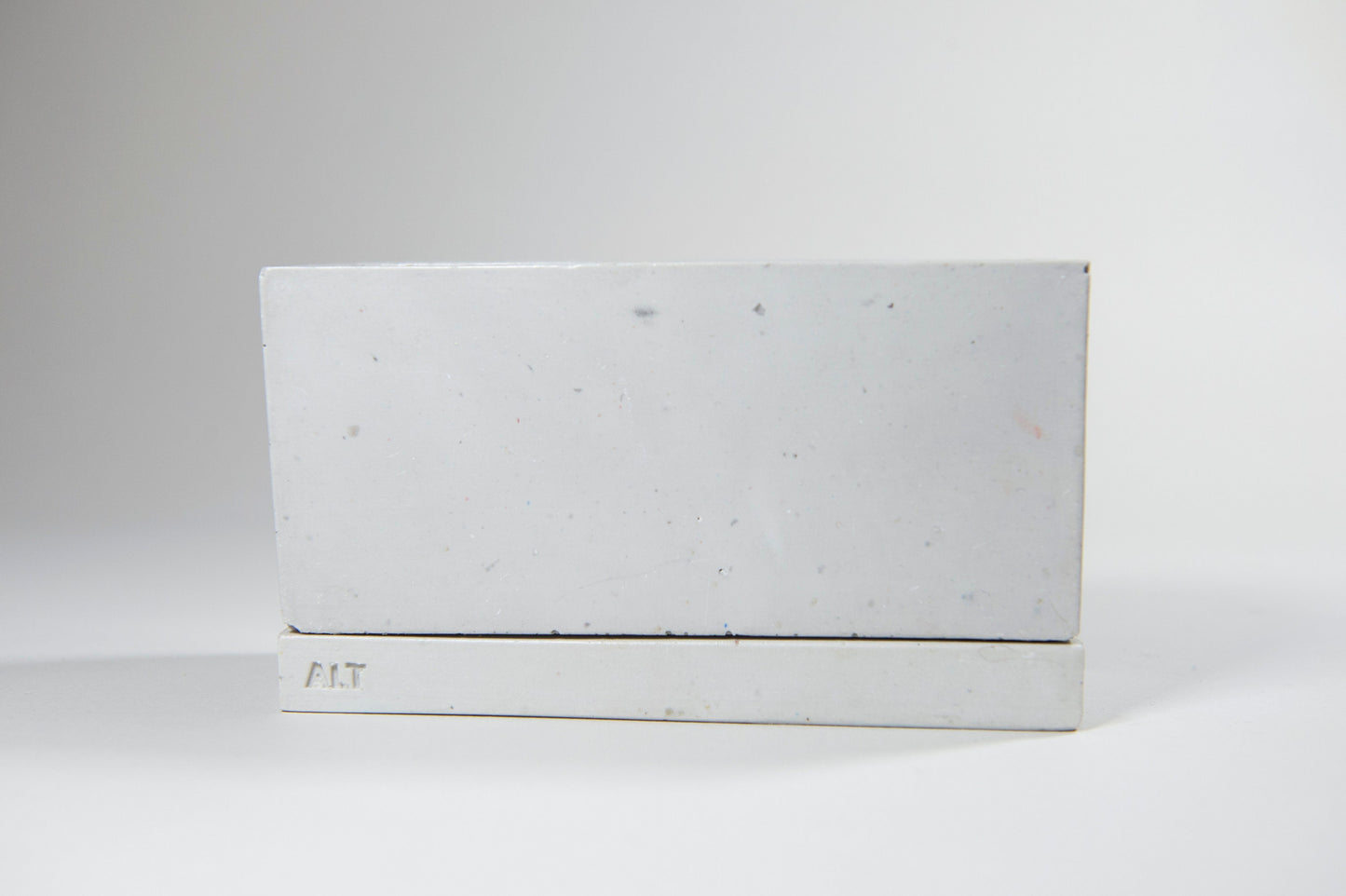 Rectangular grey planter with drainage holes and a water tray box with 'ALT' branding on a white background
