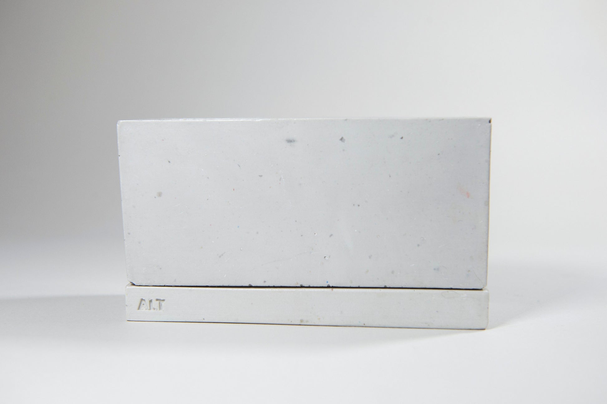 Rectangular grey planter with drainage holes and a water tray box with 'ALT' branding on a white background