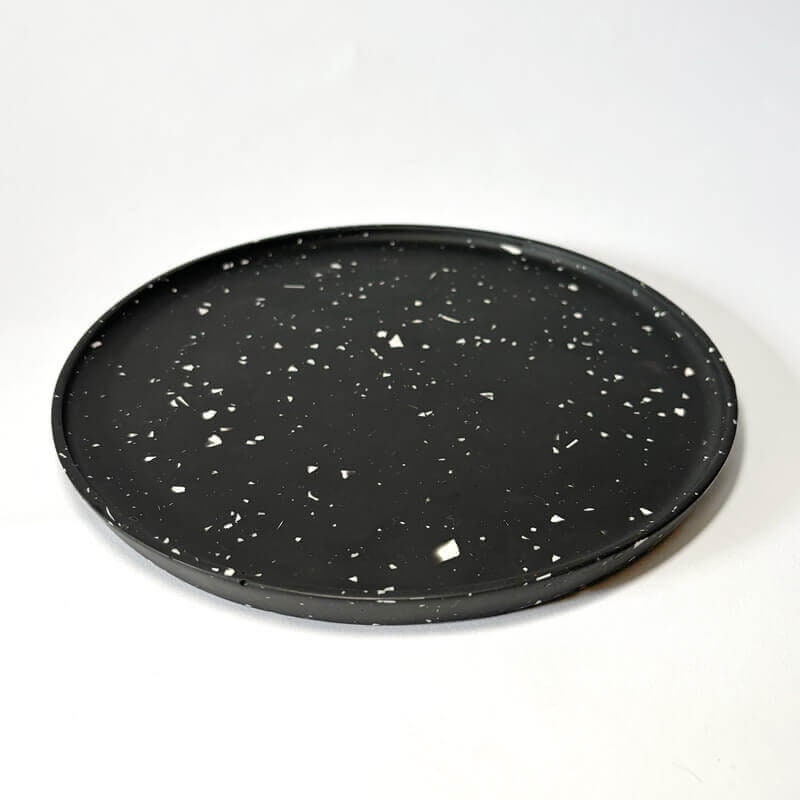 Black speckled decorative tray on a white background