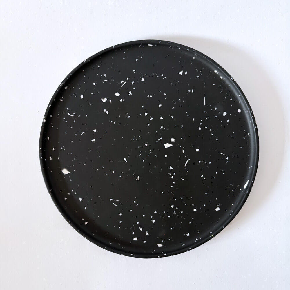 Black speckled decorative tray on a white background