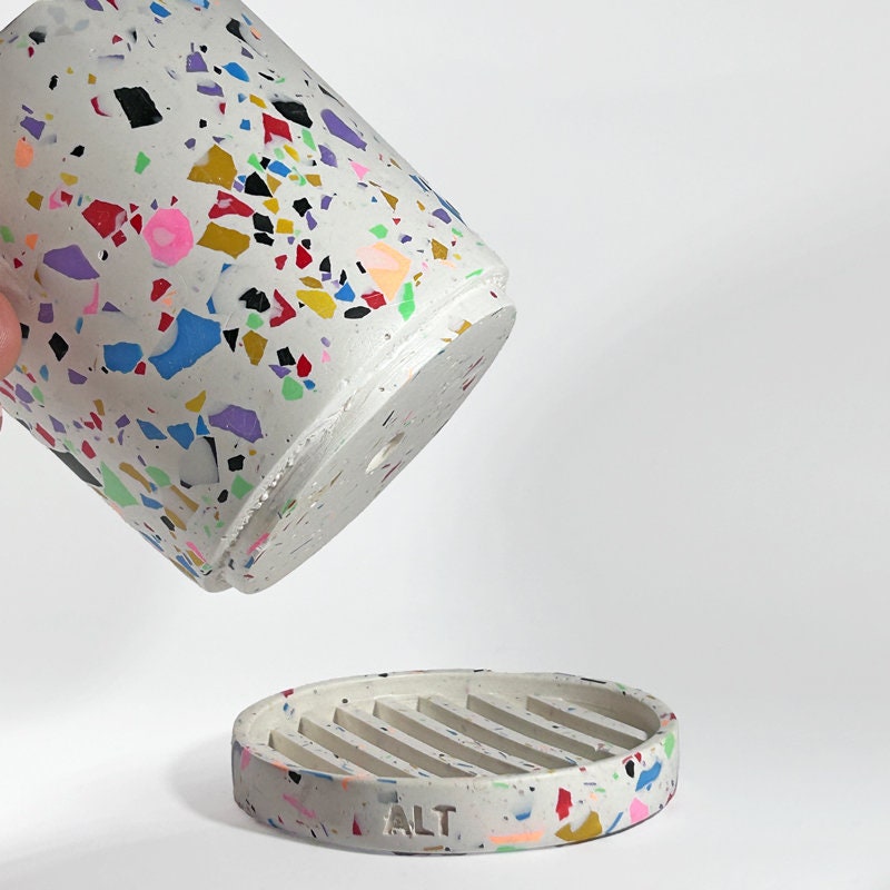 Colourful terrazzo-patterned plant pot with drainage and a separate water tray on a white background