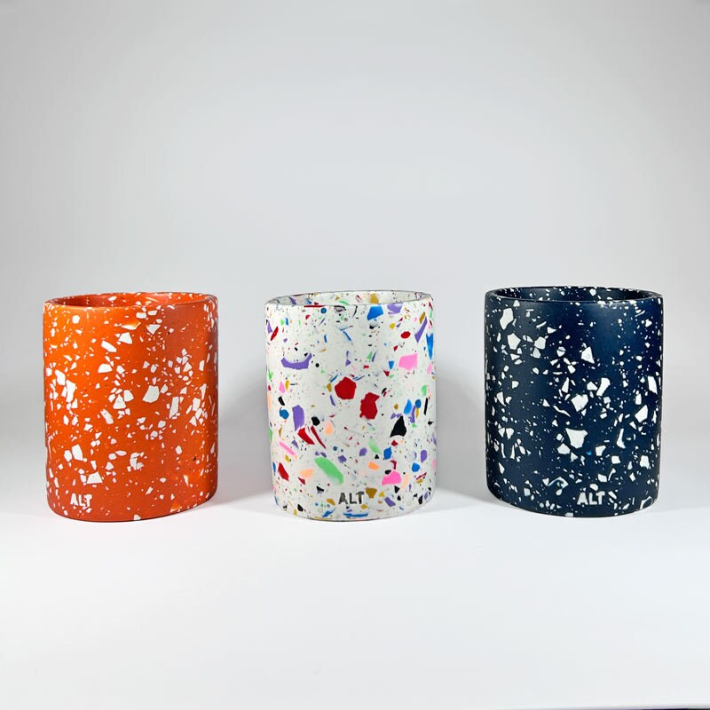 Three colorful speckled vases on a white background