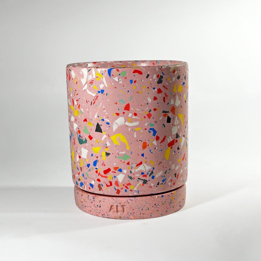 Pink terrazzo-patterned planter with a drainage hole and a water tray on a white background