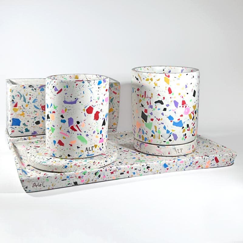 Set of Jesmonite items with colourful terrazzo design on a white background