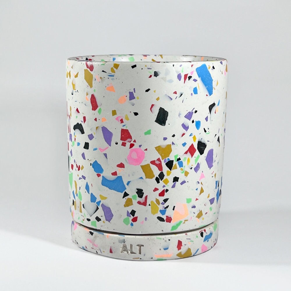 Colourful terrazzo-patterned plant pot with drainage and a separate water tray on a white background