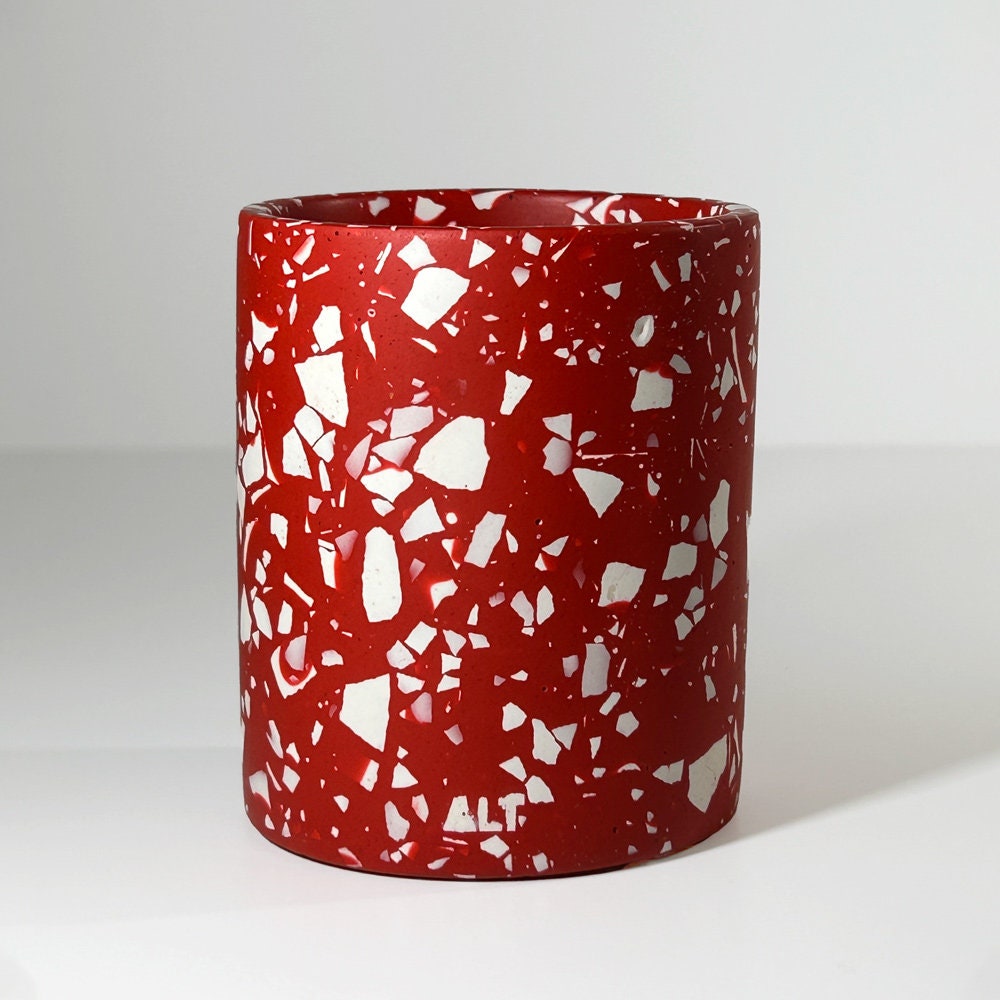 Red and white speckled container on a light gray background