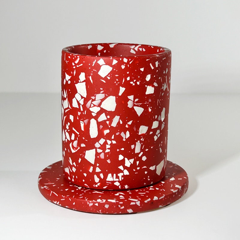 Red and white speckled planter on a white background