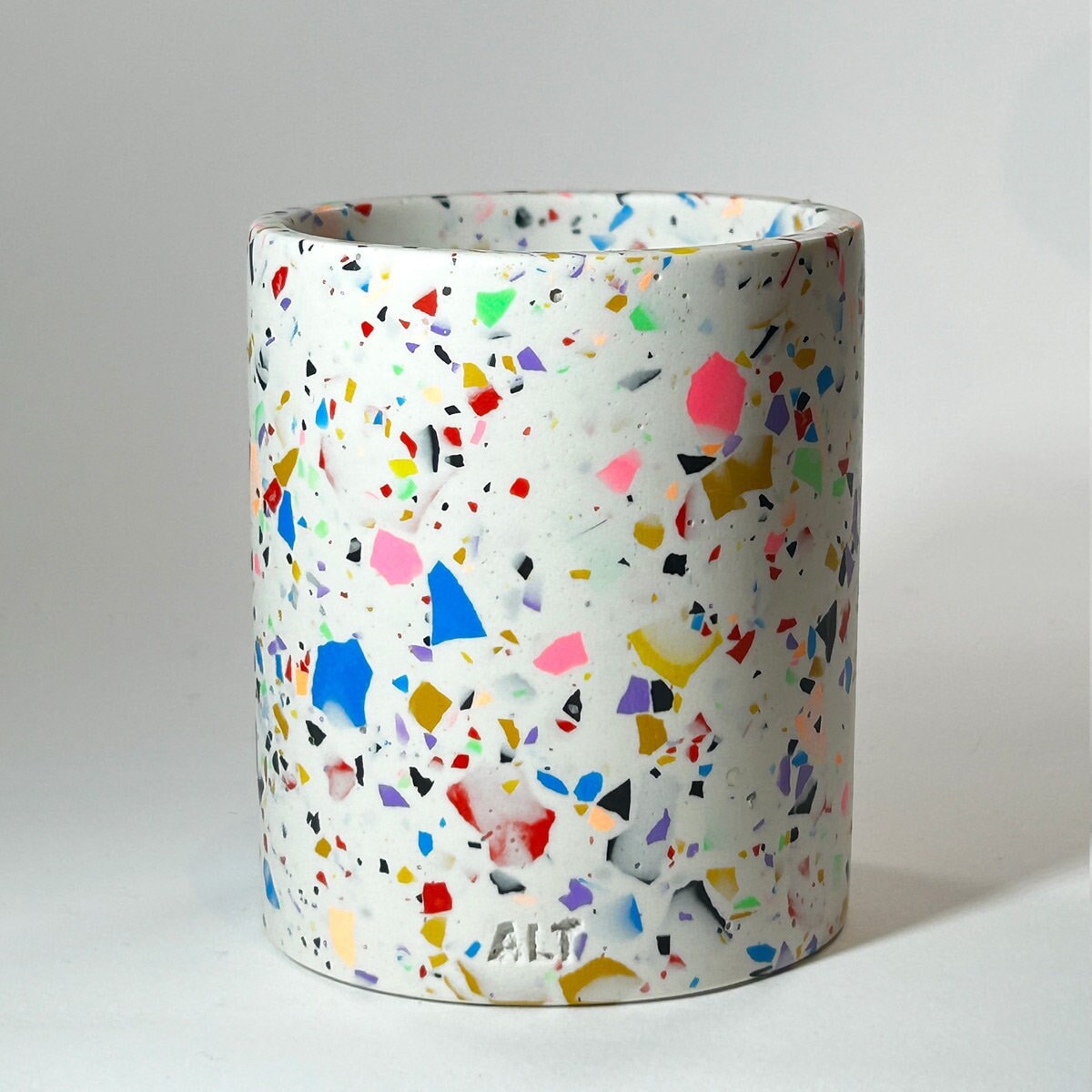 Colorful terrazzo-patterned vase on a light gray background