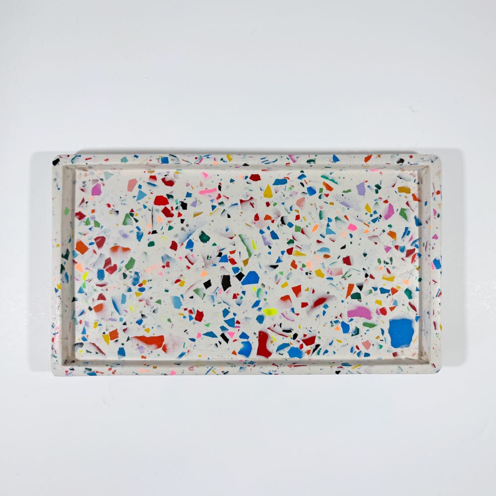 Rectangular tray with multicoloured rainbow confetti terrazzo pattern on a white background