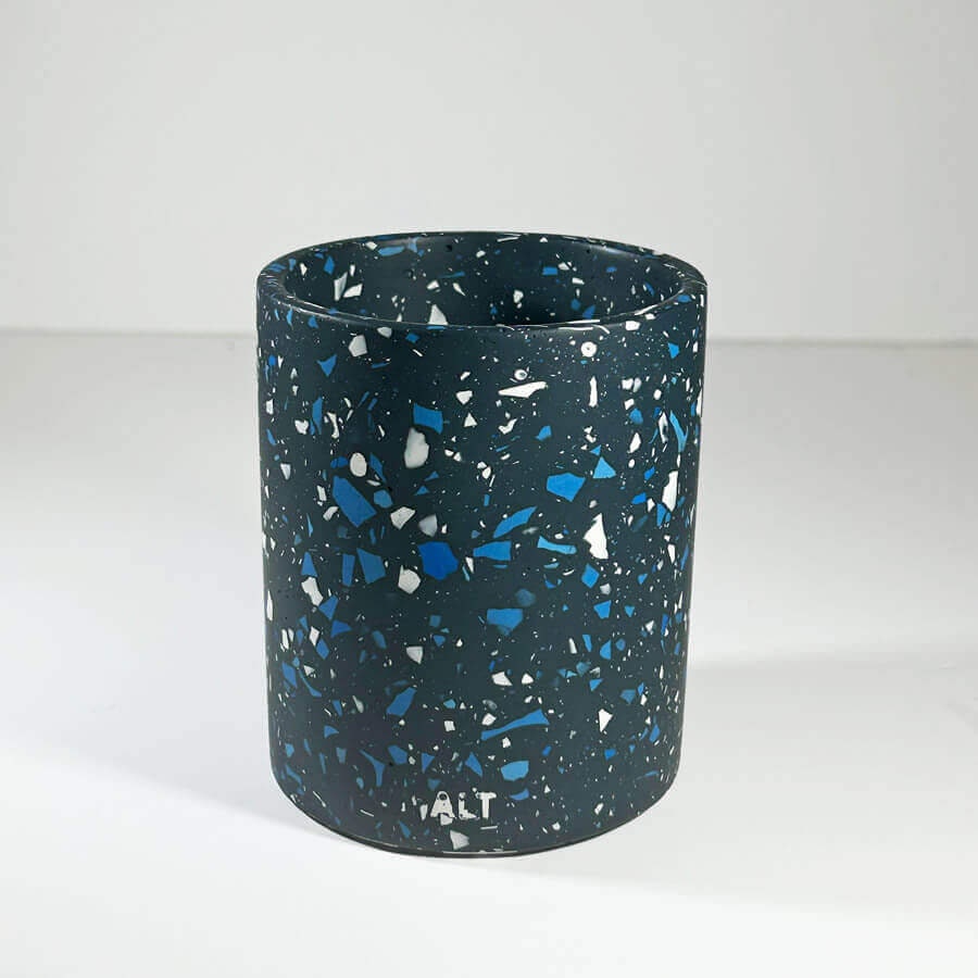 Dark blue pen pot with speckled pattern on a white background