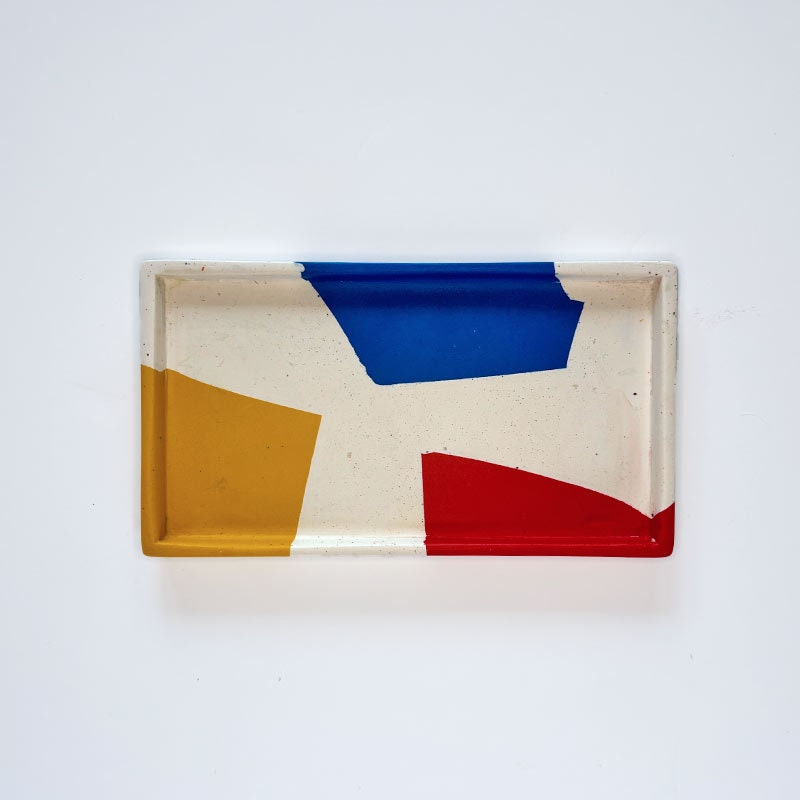 Rectangular tray with geometric colour blocks on a white background