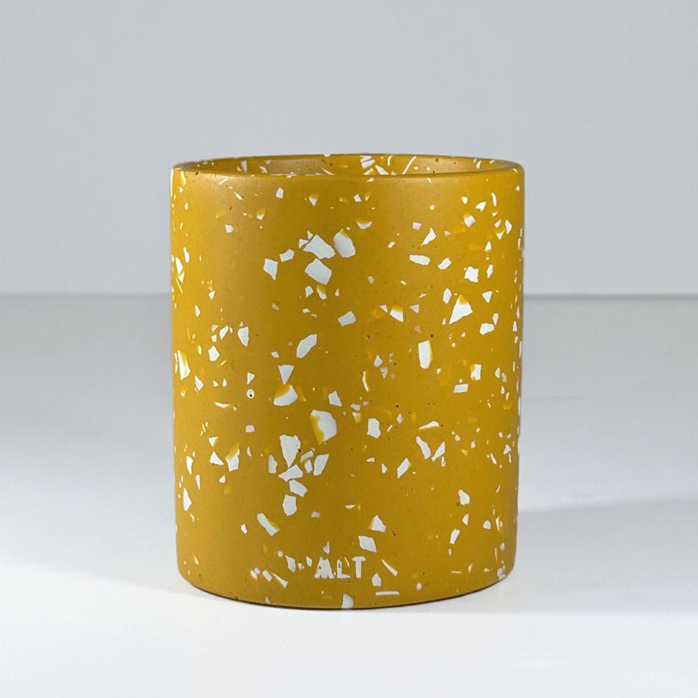 Yellow mustard pen pot with white terrazzo pattern on a white background