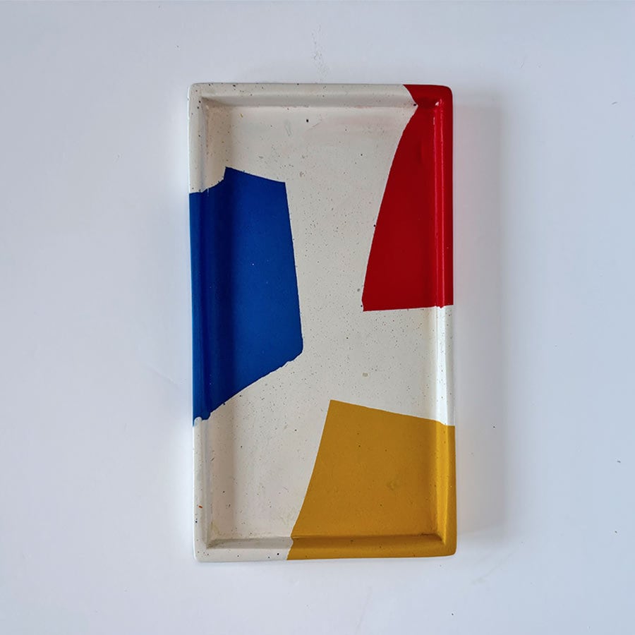 Rectangular tray with geometric colour blocks on a white background