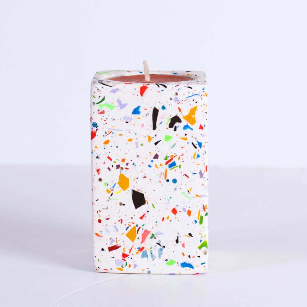 Candle with rainbow confetti rectangular tea light candle holder on a white background