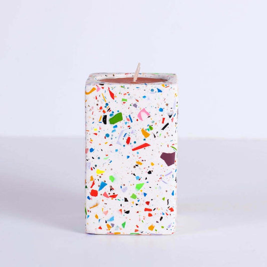 Candle with rainbow confetti rectangular tea light candle holder on a white background