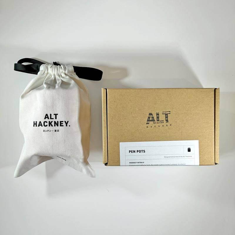 White drawstring bag and brown box with 'ALT HACKNEY' branding on a white background