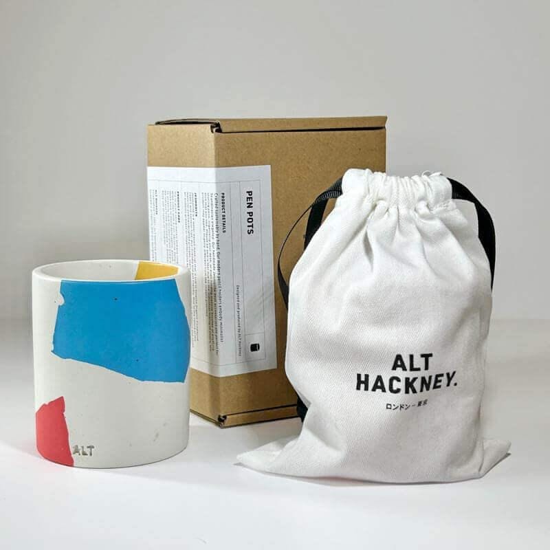 Chunky Terrazzo pen pot. branded cardboard box, and white drawstring bag with 'ALT HACKNEY' branding on a light gray background.
