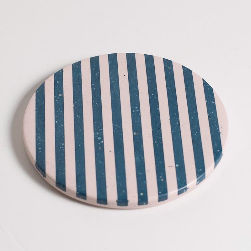 Blue and light pink checkered coaster on a white background