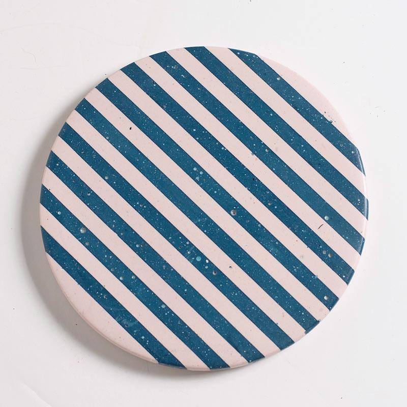 Blue and light pink checkered coaster on a white background