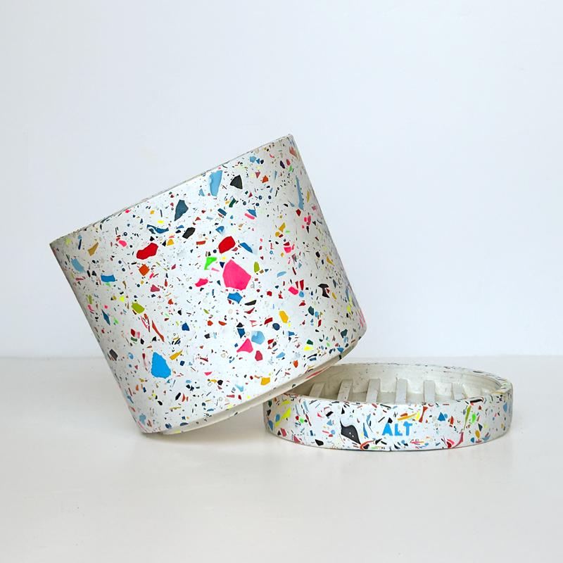 Colourful rainbow terrazzo pot on a white background