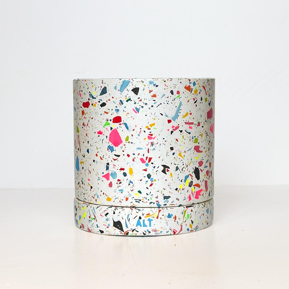 Colourful rainbow terrazzo pot on a white background