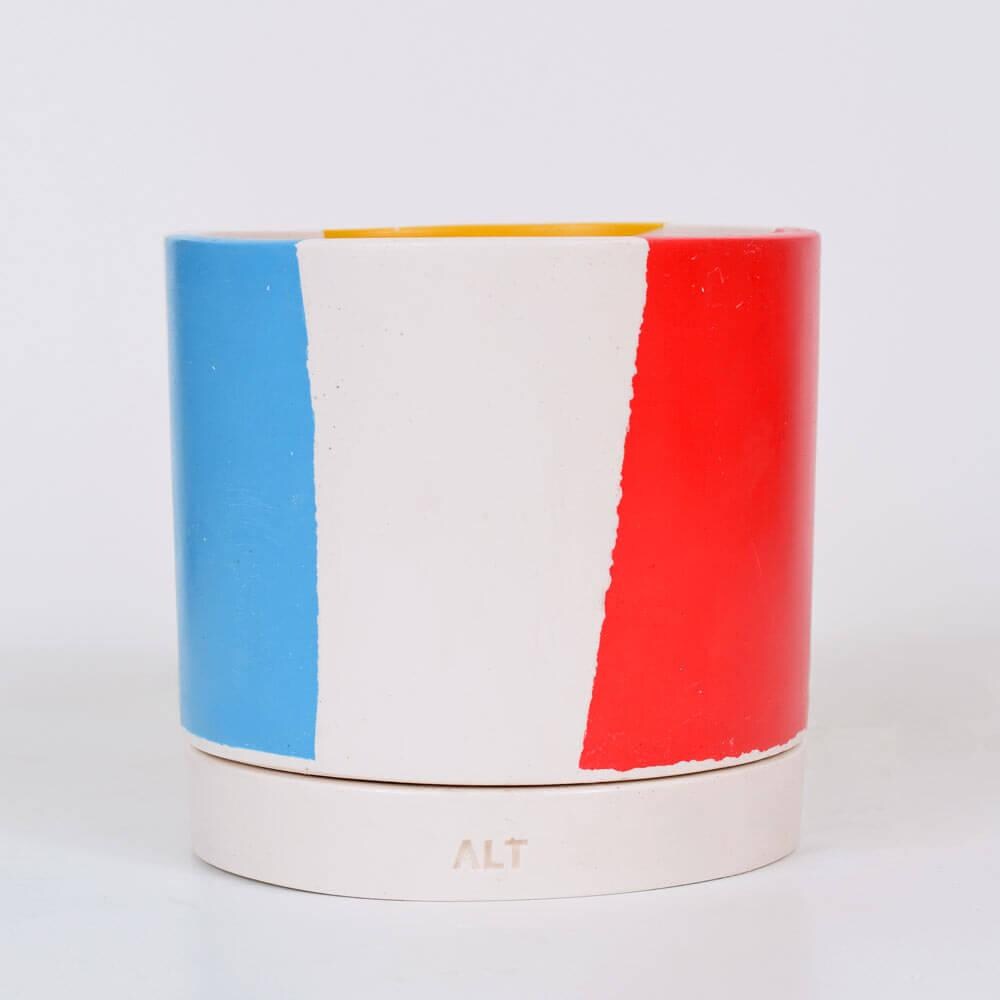 Chunky Cylindrical plant pot with blue, yellow and red stripes on a white background