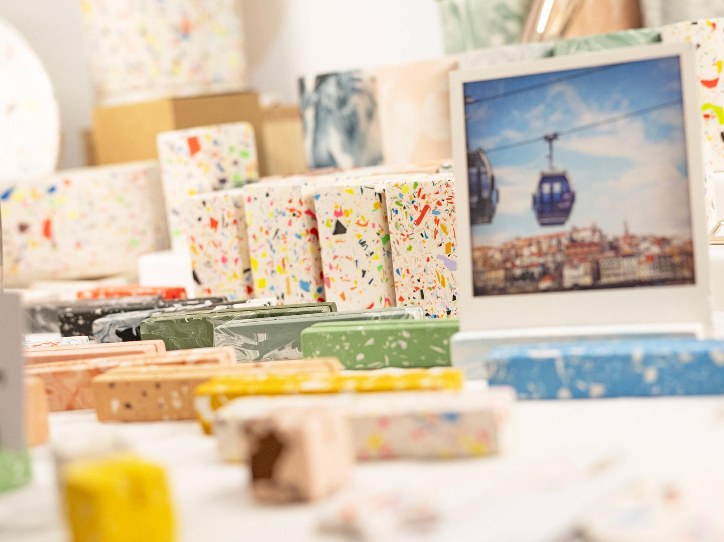 Colorful stationery items on a desk with a photo frame in the background