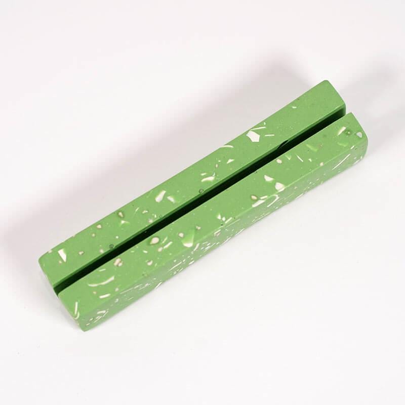 Green rubber eraser on a white background